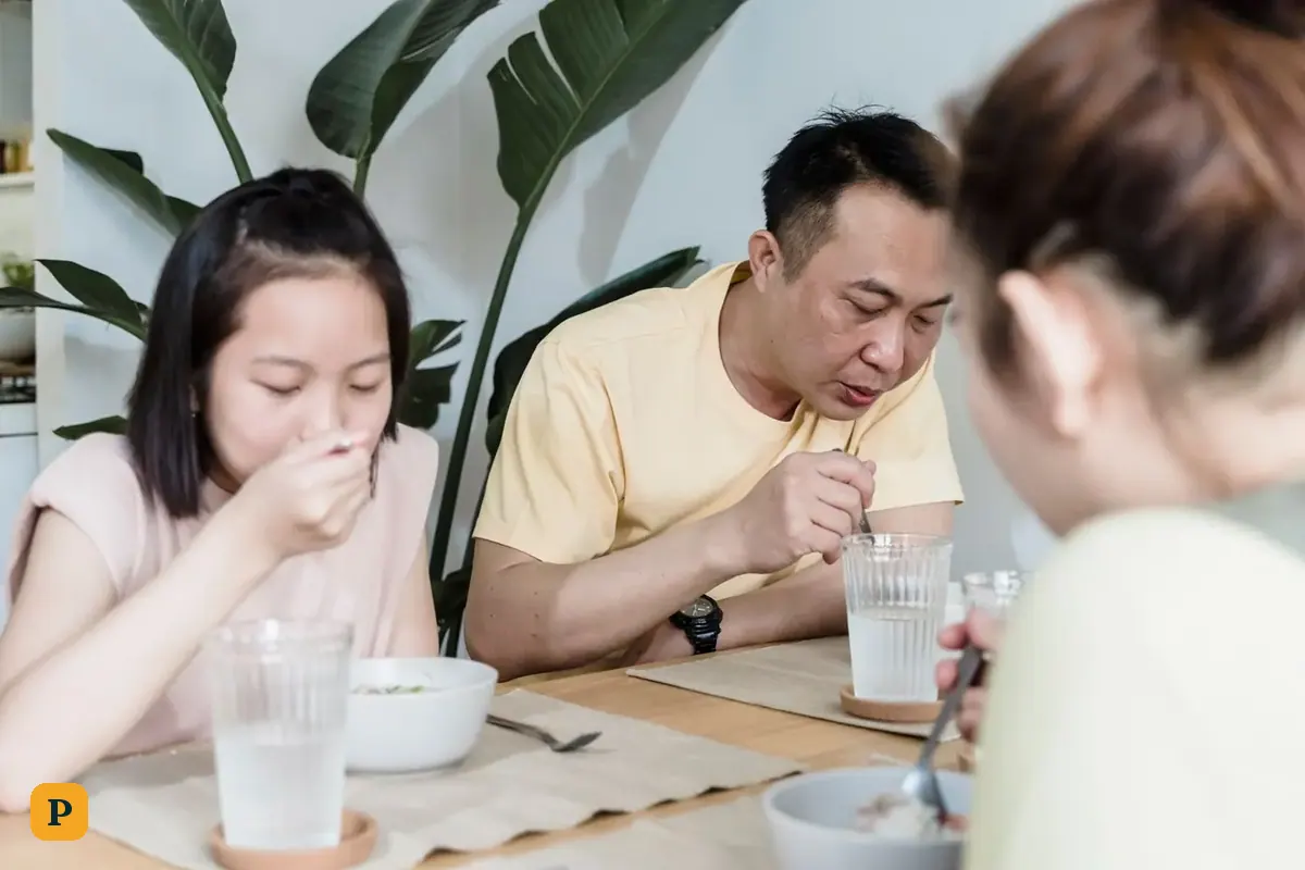A family shares a meal at the kitchen table